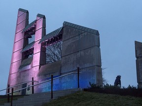 An unidentified woman walks past the bell tower before a ceremony to mark the 100th anniversary of the Halifax Explosion at Fort Needham Memorial Park in Halifax on Wednesday, Dec. 6, 2017. Two ships, the SS Imo and the SS Mont Blanc, collided in the harbour and the resulting explosion remains the worst human-made disaster in Canadian history.