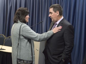 Debbie Boyd, mother of Jordan Boyd, talks with Gilles Courteau, commissioner of the Quebec Major Junior Hockey League, after a news conference in Halifax on Tuesday, Dec. 5, 2017. Jordan Boyd, 16, had an undiagnosed heart condition when he collapsed and died in Bathurst, N.B., at a training camp for the QMJHL's Acadie-Bathurst Titan, in August 2013. Courteau offered an apology from the league and introduced changes aimed at improving player safety.THE CANADIAN PRESS/Andrew Vaughan