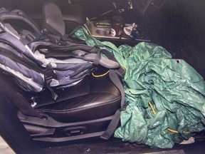 A police evidence photo of a green tarp in the front passenger area of a vehicle is seen at Nova Supreme Court in Halifax on Friday, Dec. 1, 2017. Christopher Garnier is charged with second-degree murder in the death of Truro police officer Const. Catherine Campbell. The Crown has alleged Garnier struck Campbell in the head and strangled her before placing her body in a green bin. THE CANADIAN PRESS/Andrew Vaughan