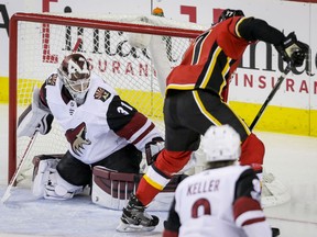 Mark Jankowskiof the Flames scores on Arizona Coyotes goalie Scott Wedgewood during second period action in Calgary on Thursday night.
