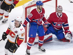 Sean Monahan of the Calgary Flames celebrates after scoring the winning goal in overtime as Montreal Canadiens' Max Pacioretty and goalie Carey Price look on during their game Thursday night in Montreal.