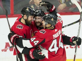 Zack Smith, left, celebrates his goal with Senators teammates Tom Pyatt and Jean-Gabriel Pageau during third period NHL action in Ottawa on Wednesday night. The Senators edged the Rangers 3-2.