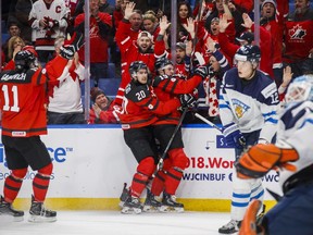 Canda's Drake Batherson, centre, celebrates his goal against Finland with teammates Michael McLeod (20) and Jonah Gadjovich at the world juniors in Buffalo on Dec. 26.