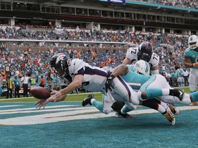 Denver Broncos quarterback Trevor Siemian (13) fumbles the ball as he is tackled by Miami Dolphins defensive end Cameron Wake (91) for safety score, during the first half of an NFL football game, Sunday, Dec. 3, 2017, in Miami Gardens, Fla.
