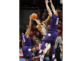 Iowa State guard Lindell Wigginton (5) drives to the basket between Kansas State's Kamau Stokes, left, and Dean Wade, right, during the first half of an NCAA college basketball game, Friday, Dec. 29, 2017, in Ames, Iowa.