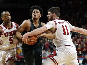 Iowa State guard Lindell Wigginton, center, drives between Northern Illinois' Justin Thomas, left, and Noah McCarty, right, during the first half of an NCAA college basketball game, Monday, Dec. 4, 2017, in Ames, Iowa.