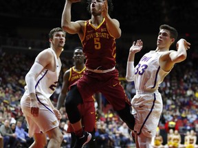 Iowa State guard Lindell Wigginton (5) drives to the basket between Northern Iowa's Bennett Koch, left, and Wyatt Lohaus, right, during the first half of an NCAA college basketball game, Saturday, Dec. 16, 2017, in Des Moines, Iowa.