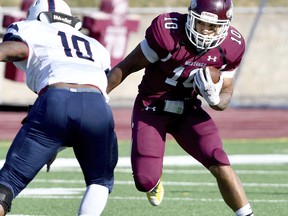 Morningside's Bubba Jenkins (10) carries the ball towards Sterling's Sam Cusack (10) during an NCAA college football game in Sioux City, Iowa on Saturday, Nov. 18, 2017. Southern Oregon quarterback Tanner Trosin and Morningside running back Bubba Jenkins lead The Associated Press NAIA All-America team released Friday, Dec. 15, 2017.