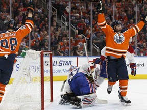 Patrick Maroon, right, and Jesse Puljujarvi of the Oilers celebrate Connor McDavid's goal against Montreal's Antti Niemi during the first period of their  game in Edmonton on Saturday night.