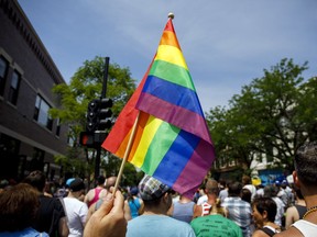 FILE - In this June 11, 2017 file photo people attend the LGBTQ Chicago Equality rally in the Andersonville neighborhood of Chicago. Starting in January 2018, Illinois is outlawing a rare criminal defense argument allowing the use of a victim's sexual orientation as justification for violent crime. It's a ban that gay rights advocates hope to replicate in about half a dozen states next year. Illinois follows California in outlawing the so-called "gay panic defense." It isn't common, but one study shows it's surfaced in roughly half of U.S. states since the 1960s.