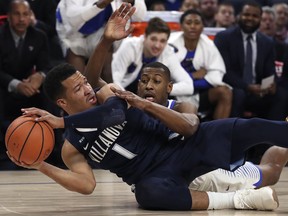 Villanova's Jalen Brunson tries to keep the ball from DePaul's Brandon Cyrus during the first half of an NCAA college basketball game Wednesday, Dec. 27, 2017, in Chicago.