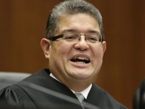 FILE - In this Nov. 25, 2013 file photo, Chief U.S. District Judge Ruben Castillo speaks from the bench in Chicago. A question raised nationwide about whether federal agents display racial bias by staging phony stash-house stings overwhelmingly in black neighborhoods is the focus of landmark hearings in Chicago.A rare panel of federal trial judges including Castillo begins two days of hearings Thursday Dec. 14, 2017, on the stings.