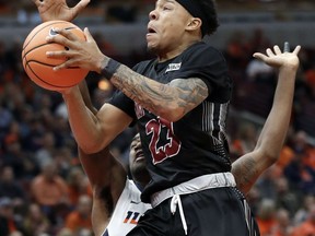 New Mexico State guard Zach Lofton (23) drives to the basket against Illinois guard Da'Monte Williams during the first half of an NCAA college basketball game Saturday, Dec. 16, 2017, in Chicago.