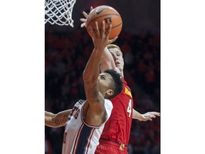 Illinois guard Te'Jon Lucas shoots as Maryland guard Kevin Huerter (4) defends during an NCAA college basketball game in Champaign, Ill., Sunday, Dec. 3, 2017.