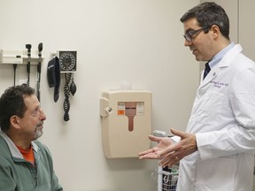 In this Dec. 1, 2017 photo, patient Daniel Lobello, left, speaks with Dr. Matthias Hofer, a urologist at Northwestern Memorial Hospital in Chicago. Lobello, 60, thinks a lot of men probably would start using cheaper generic or brand-name Viagra. "It's great" that the prices are getting cut, said the electrical inspector, "because it's something men need."