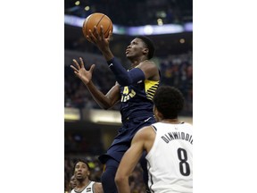 Indiana Pacers guard Victor Oladipo (4) shoots in front of Brooklyn Nets guard Spencer Dinwiddie (8) during the first half of an NBA basketball game in Indianapolis, Saturday, Dec. 23, 2017.