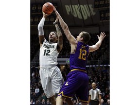 Purdue forward Vincent Edwards, left, shoots while defended by Lipscomb forward Matt Rose, right, in the first half of an NCAA college basketball game, Saturday, Dec. 30, 2017, in West Lafayette, Ind.