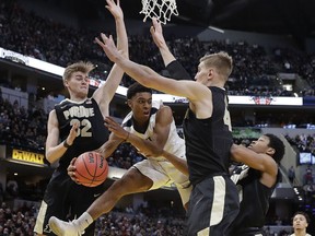 Butler's Aaron Thompson makes a pass against Purdue's Matt Haarms (32) and Isaac Haas (44) during the first half of an NCAA college basketball game, Saturday, Dec. 16, 2017, in Indianapolis.