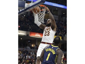 Cleveland Cavaliers' LeBron James (23) dunks against Indiana Pacers' Lance Stephenson during the first half of an NBA basketball game Friday, Dec. 8, 2017, in Indianapolis.