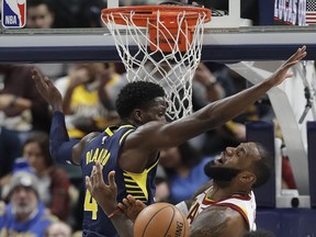 Cleveland Cavaliers' LeBron James is fouled by Indiana Pacers' Victor Oladipo as he goes up for a shot during the second half of an NBA basketball game Friday, Dec. 8, 2017, in Indianapolis. The Pacers won 106-102.