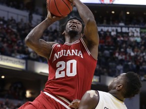 Indiana's De'Ron Davis (20) shoots over Notre Dame's TJ Gibbs (10) during the first half of an NCAA college basketball game, Saturday, Dec. 16, 2017, in Indianapolis.