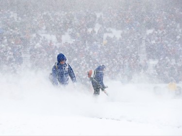 ORCHARD PARK, NY - DECEMBER 10: Workers blow snow off the field during the first quarter of a game between the Buffalo Bills and Indianapolis Colts on December 10, 2017 at New Era Field in Orchard Park, New York.  (Photo by Tom Szczerbowski/Getty Images)