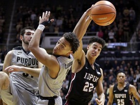 IUPUI guard D.J. McCall (22) knocks a rebound away from Purdue guard Carsen Edwards (3) in the first half of an NCAA college basketball game in West Lafayette, Ind., Sunday, Dec. 10, 2017.