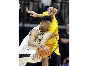 Purdue forward Vincent Edwards (12) tries to gets through the defense of Valparaiso center Jaume Sorolla (14) during the first half of an NCAA college basketball game in West Lafayette, Ind., Thursday, Dec. 7, 2017.