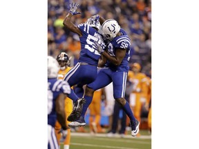 Indianapolis Colts outside linebacker Barkevious Mingo (52) celebrates a sack with linebacker Tarell Basham (58) during the first half of an NFL football game against the Denver Broncos in Indianapolis, Thursday, Dec. 14, 2017.