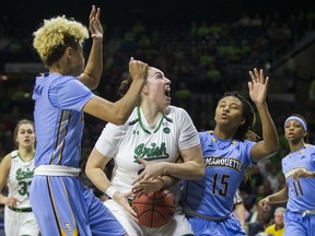 Notre Dame's Jessica Shepard, center, gets the ball knocked away by Marquette's Amani Wilborn (15) next to Natisha Hiedeman, left, during the first half of an NCAA women's college basketball game Wednesday, Dec. 20, 2017, in South Bend, Ind.