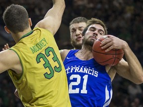 St. Francis (NY)'s Milija Cosic (21) grabs a rebound between Notre Dame's John Mooney (33) and Martinas Geben during the first half of an NCAA college basketball game Sunday, Dec. 3, 2017, in South Bend, Ind.