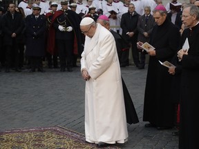Pope Francis prays in front of the statue of the Virgin Mary, near Rome's Spanish Steps Friday, Dec. 8, 2017, an annual tradition marking the start of the city's holiday season.
