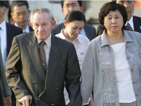 In this July 18, 2004 file photo, former U.S. Army deserter to North Korea, Charles Jenkins, left, escorted by his wife Hitomi Soga, right, and their daughter Mika, center, arrives at Tokyo's Haneda International Airport.