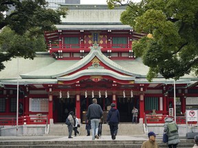 People visit Tomioka Hachimangu shrine in Tokyo Friday, Dec. 8, 2017.