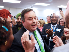 Jason Kenney works his way through supporters at his campaign headquarters after  winning the Calgary-Lougheed byelection on Thursday Dec. 14, 2017.