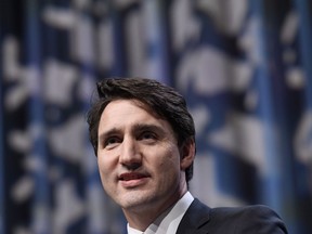 Prime Minister Justin Trudeau waves after speaking at the National Liberal Caucus Holiday Party in Ottawa on Wednesday, Dec. 13, 2017.