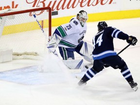 Josh Morrissey of the Winnipeg Jets redirects a shot behind Vancouver Canucks' goaltender Jacob Markstrom during NHL action Monday night in Winnipeg. The Jets ended a three-game losing skid with a 5-1 victory.