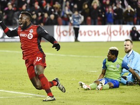 Toronto FC forward Jozy Altidore (17) celebrates after scoring against Seattle Sounders goalkeeper Stefan Frei, right, as defender Joevin Jones looks on during second half MLS Cup Final soccer action in Toronto on Saturday, December 9, 2017.