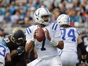 Indianapolis Colts quarterback Jacoby Brissett (7) looks for a receiver as he is rushed by Jacksonville Jaguars defensive lineman Calais Campbell (93) during the first half of an NFL football game, Sunday, Dec. 3, 2017, in Jacksonville, Fla.