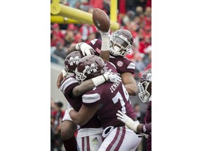 Mississippi State running back Aeris Williams (22) celebrates a touchdown with his team mates during the first half of the TaxSlayer Bowl NCAA college football game against Louisville, Saturday, Dec. 30, 2017, in Jacksonville, Fla.