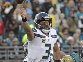 Seattle Seahawks quarterback Russell Wilson (3) releases a pass as he is hit by Jacksonville Jaguars defensive lineman Calais Campbell during the first half of an NFL football game, Sunday, Dec. 10, 2017, in Jacksonville, Fla.