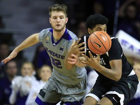 Kansas State forward Dean Wade (32) knocks the ball away from South Carolina Upstate center Isaiah Anderson, right, during the first half of an NCAA college basketball game in Manhattan, Kan., Tuesday, Dec. 5, 2017.