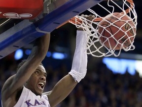 Kansas guard Lagerald Vick dunks during the first half of an NCAA college basketball game against Arizona State in Lawrence, Kan., Sunday, Dec. 10, 2017.