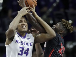 Southeast Missouri State guard Daniel Simmons (23) rebounds against Kansas State forward Levi Stockard III (34) during the first half of an NCAA college basketball game in Manhattan, Kan., Saturday, Dec. 16, 2017.