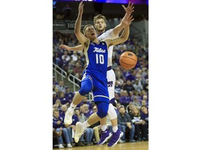Tulsa guard Curran Scott (10) loses the ball while defended by Kansas State forward Dean Wade, back, during the first half of an NCAA college basketball game in Wichita, Kan., Saturday, Dec. 9, 2017.