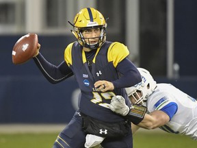 Texas A&M-Commerce Lions quarterback Luis Perez (12) is pressured by West Florida Argonauts defensive lineman John Williamson (30) during the first quarter of their NCAA Division II college football championship game in Kansas City, Kan., Saturday, Dec. 16, 2017.