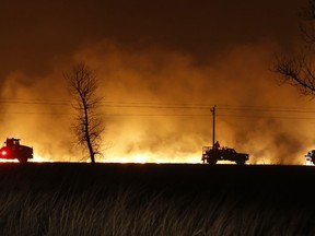 FILE - In this March 6, 2017 file photo, firefighters from across Kansas and Oklahoma battle a  wildfire near Protection, Kan. The La Nina climate phenomenon in the south Pacific Ocean is contributing to weather conditions that are expected to be warm and dry with low humidity, leading to fears of a sharp increase in winter wildfires from the mid-South through the Great Plains.