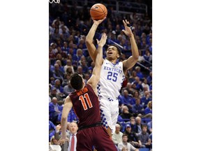 Kentucky's Pj Washington (25) shoots while being defended by Virginia Tech's Devin Wilson (11) during the first half of an NCAA college basketball game, Saturday, Dec. 16, 2017, in Lexington, Ky.