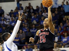 Louisville's Asia Durr, right, shoots while defended by Kentucky's Amanda Paschal during the first half of an NCAA college basketball game, Sunday, Dec. 17, 2017, in Lexington, Ky.