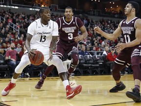 Cincinnati's Tre Scott (13) looks to pass against Mississippi State's Xavian Stapleton (3) and Quinndary Weatherspoon (11) in the first half of an NCAA college basketball game, Tuesday, Dec. 12, 2017, in Highland Heights, Ohio.